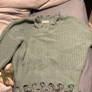Green sweater, great condition, strings on the bottom and bottom of sleeves